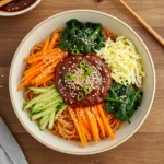 Bibim recipe noodle bowl with spicy sauce and vegetables