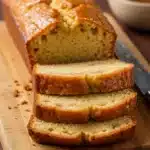 Glazed apple cider pound cake sliced on wooden board