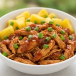 Crockpot Pineapple BBQ Chicken served in a bowl with pineapple chunks and green onions