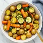 Garlic Herb Roasted Potatoes Carrots and Zucchini on rustic table
