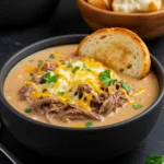 Philly Cheese Steak Soup topped with melted cheddar and parsley