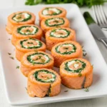 Spinach and Feta Stuffed Salmon Pinwheels on serving platter