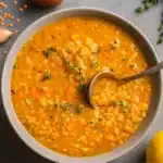 anti-inflammatory lentil soup in a bowl with parsley and lemon