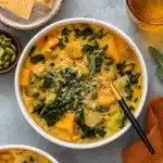 butternut squash kale and white bean soup in rustic bowl