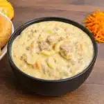 cheeseburger macaroni soup in bowl with cheddar