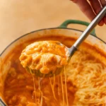 chicken parm soup in rustic bowl with pasta and melted cheese