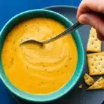 Instant Pot Carrot Ginger Soup in a bowl with coconut swirl