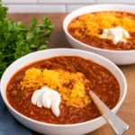 Bowl of homemade No Bean Chili topped with cheese and sour cream