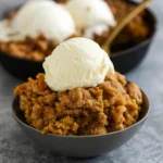 Pumpkin Crisp with cinnamon streusel topping served warm with ice cream