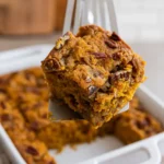 Pumpkin Pecan Coffee Cake square with pecans lifted from baking dish
