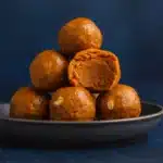 Pumpkin Protein Balls on a plate with oats.