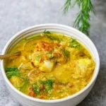roasted cauliflower soup served in bowl with dill garnish