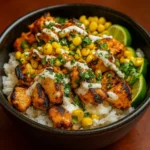 Street Corn Chicken Rice Bowl Recipe in ceramic bowl with avocado and cotija cheese