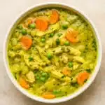 anti inflammatory turmeric chicken soup in a rustic bowl