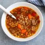 hearty beef barley soup in rustic bowl