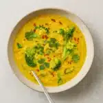 Broccoli-Quinoa Soup With Turmeric and Ginger in a rustic bowl