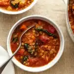 Mediterranean Lentil Soup in rustic bowl with herbs and lemon