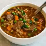 Rustic bowl of Pioneer Woman Beef Barley Soup served with crusty bread