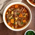 Pot Roast Soup in rustic bowl with beef and vegetables