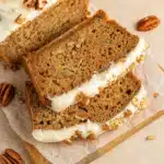 Spiced Apple Zucchini Bread with Cream Cheese Glaze on rustic table