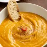 Spicy Pumpkin Soup served in a bowl with fall decor
