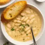 Vegan Rosemary Garlic White Bean Soup served with crusty bread