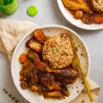Best Jamaican Brown Stew Chicken served with rice and peas