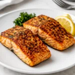 Air Fryer Salmon on a plate with lemon and parsley
