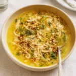 Lemon Chicken Couscous Soup in bowl with dill garnish