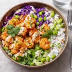 Shrimp Poke Bowl with rice, veggies, and sriracha mayo