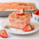 Strawberry Crunch Poke Cake with strawberry gelatin and Oreo topping