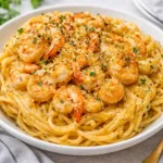 Creamy Bang Bang Shrimp Pasta with succulent shrimp and cilantro garnish.
