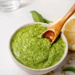 basil pesto in jar with ingredients