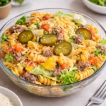Big Mac Pasta Salad in a large serving bowl with beef, cheese, and pickles
