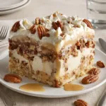 butter pecan praline poke cake with caramel and whipped cream