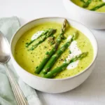 Creamy Asparagus Soup in bowl with toppings
