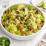 Mexican Caesar Salad in a wooden bowl with avocado and corn