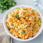 A large bowl of creamy Fritos Corn Salad topped with crunchy chips and cilantro.