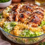 Creamy Chicken Caesar Pasta Salad in a white bowl on a wooden table