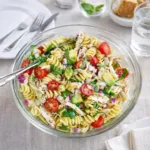 Healthy Chicken Pasta Salad with Avocado, Tomato, and Basil in a white bowl