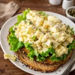 Zesty Lemon Caper Egg Salad Recipe in a white bowl with fresh dill.
