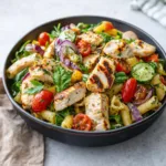 Fresh Mediterranean Chicken Pasta Salad with feta and olives in a white bowl.