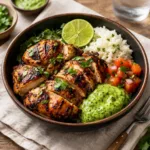 Peruvian Grilled Chicken platter with green sauce and lime
