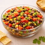 A large bowl of Pioneer Woman Cowboy Caviar Recipe served with tortilla chips.